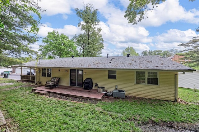 rear view of house with a wooden deck, a lawn, and central AC