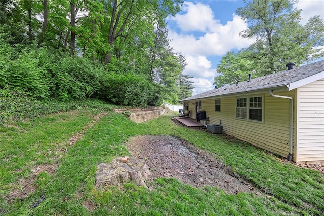 view of grassy yard with central AC unit