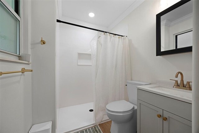 bathroom featuring toilet, wood finished floors, a shower with shower curtain, ornamental molding, and vanity