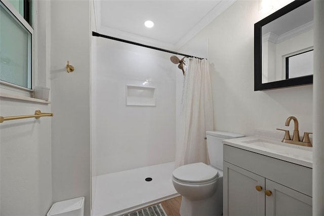 full bathroom with toilet, ornamental molding, a shower with curtain, wood finished floors, and vanity
