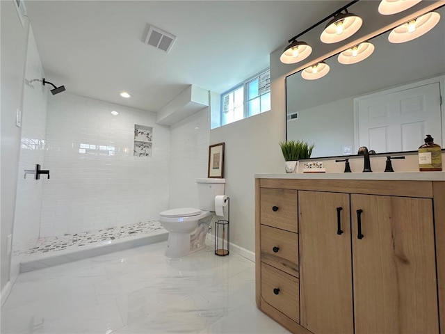 bathroom with walk in shower, toilet, vanity, marble finish flooring, and baseboards