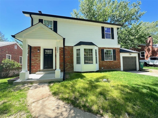 view of front of house with a front yard, brick siding, a garage, and concrete driveway