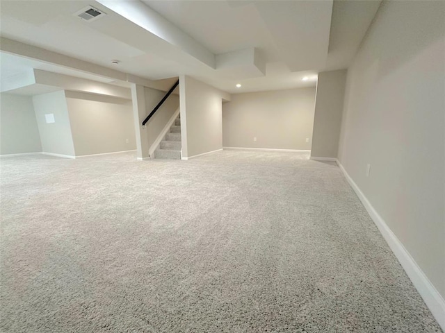 finished below grade area featuring stairs, carpet, baseboards, and recessed lighting