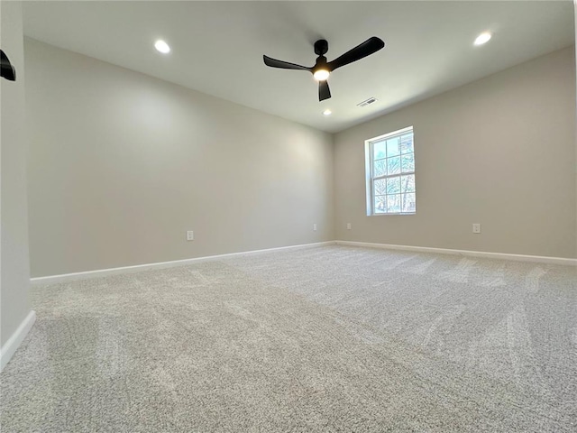 carpeted spare room with a ceiling fan, baseboards, and recessed lighting