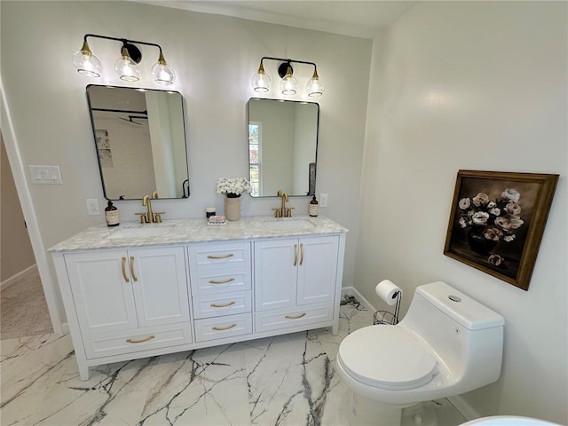 full bath with marble finish floors, baseboards, toilet, and double vanity