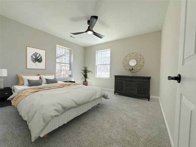 carpeted bedroom with baseboards and a ceiling fan