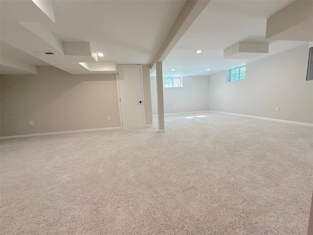 below grade area featuring baseboards, recessed lighting, and carpet flooring