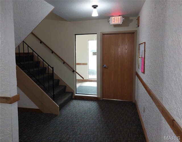 1380 Heritage Lndg Unit 105, Frontier Township, MO 63303 - entryway with a textured wall, a textured ceiling, carpet floors, and stairs