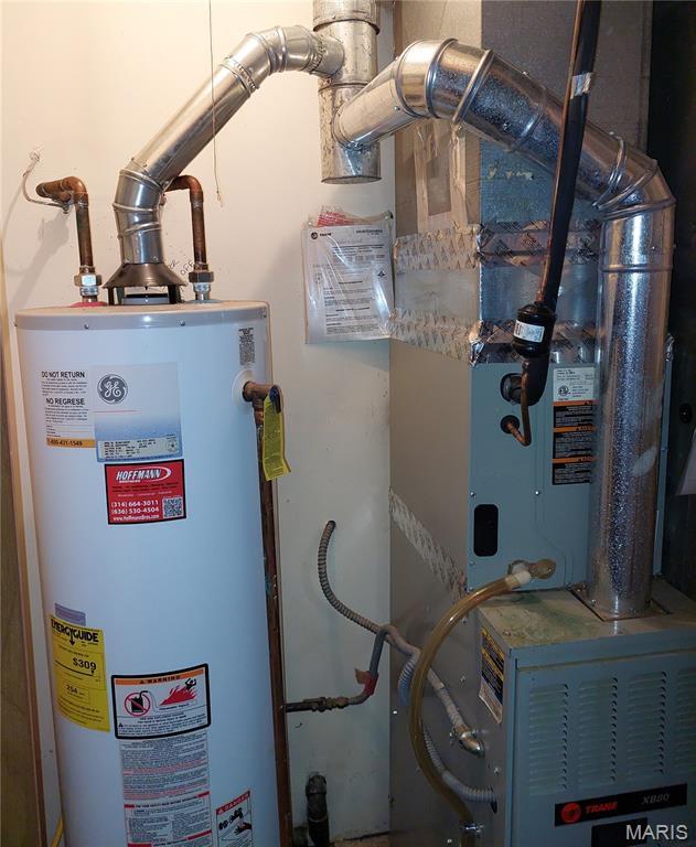 1380 Heritage Lndg Unit 105, Frontier Township, MO 63303 - utility room featuring gas water heater and heating unit
