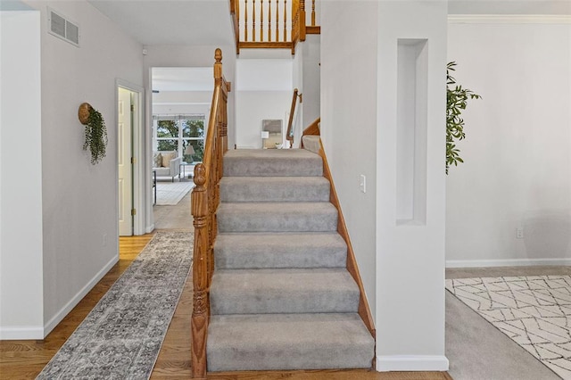 stairs featuring baseboards and wood finished floors