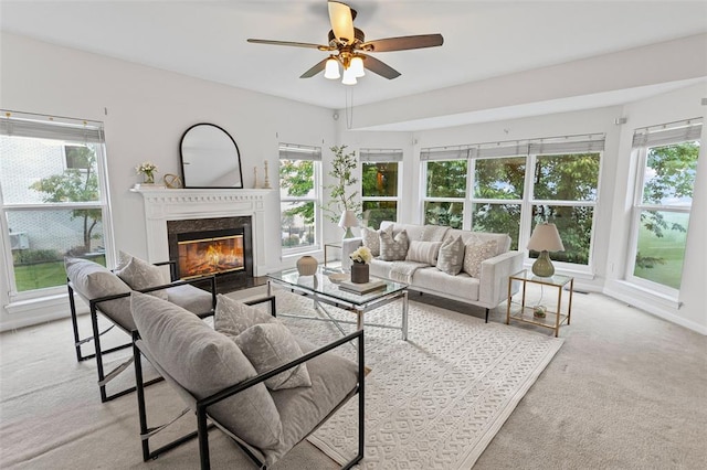 living room with healthy amount of natural light, a high end fireplace, and carpet flooring