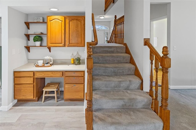 staircase featuring baseboards