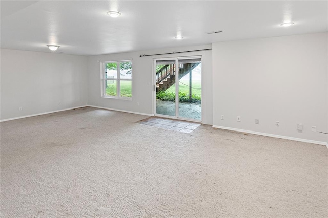 unfurnished room featuring carpet and baseboards
