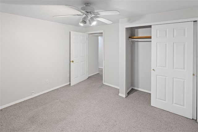 unfurnished bedroom with carpet floors, baseboards, a closet, and ceiling fan