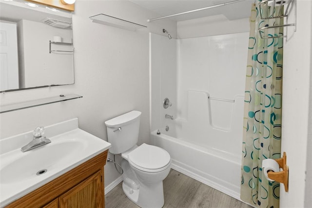 bathroom with toilet, shower / tub combo with curtain, vanity, wood finished floors, and baseboards