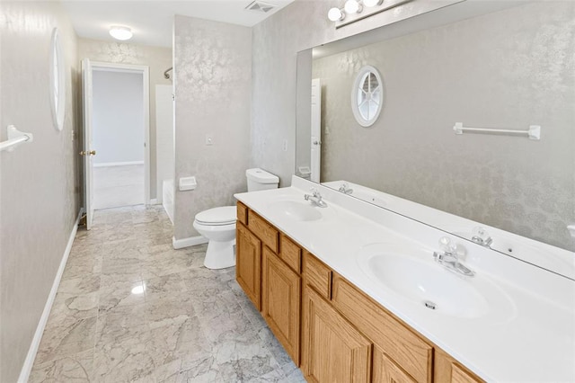 bathroom featuring baseboards, toilet, marble finish flooring, and double vanity