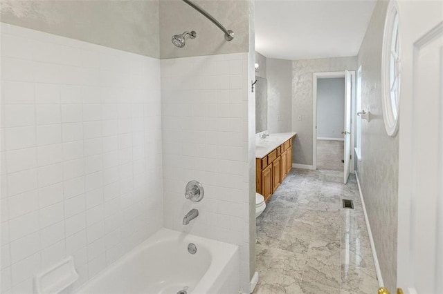 bathroom with shower / washtub combination, vanity, baseboards, and toilet