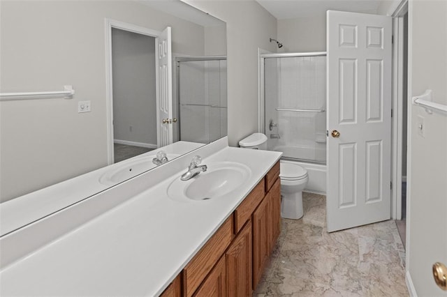 full bathroom with vanity, toilet, bath / shower combo with glass door, and marble look tiles