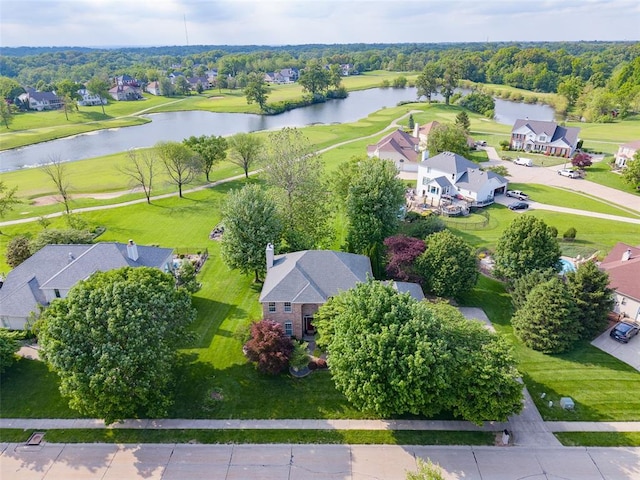 aerial perspective of suburban area with a nearby body of water and a local golf course