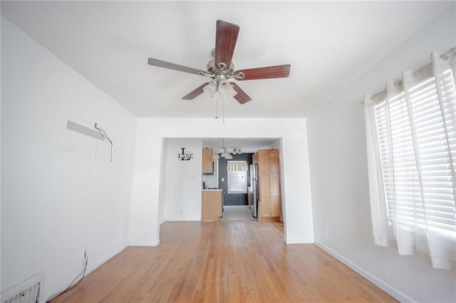 225 Haller Ave, East Alton, IL 62024 - empty room with ceiling fan, light wood-style floors, baseboards, and a chandelier