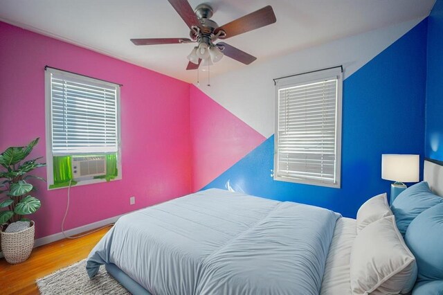 225 Haller Ave, East Alton, IL 62024 - bedroom with wood finished floors, cooling unit, multiple windows, and baseboards