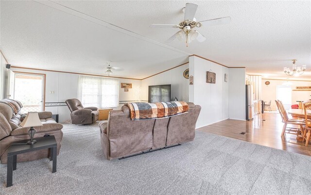 442 County Road 6250, Salem, MO 65560 - living area featuring carpet flooring, a ceiling fan, ornamental molding, a textured ceiling, and a chandelier