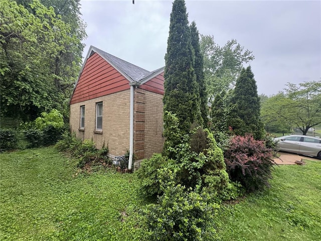 206 Thoroughman Ave, Ferguson, MO 63135 - view of property exterior featuring brick siding and a yard