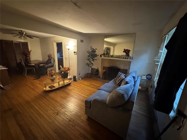 206 Thoroughman Ave, Ferguson, MO 63135 - living room featuring hardwood / wood-style floors, a ceiling fan, a fireplace, and baseboards
