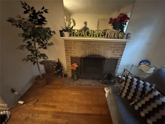 206 Thoroughman Ave, Ferguson, MO 63135 - living room featuring a brick fireplace and wood finished floors