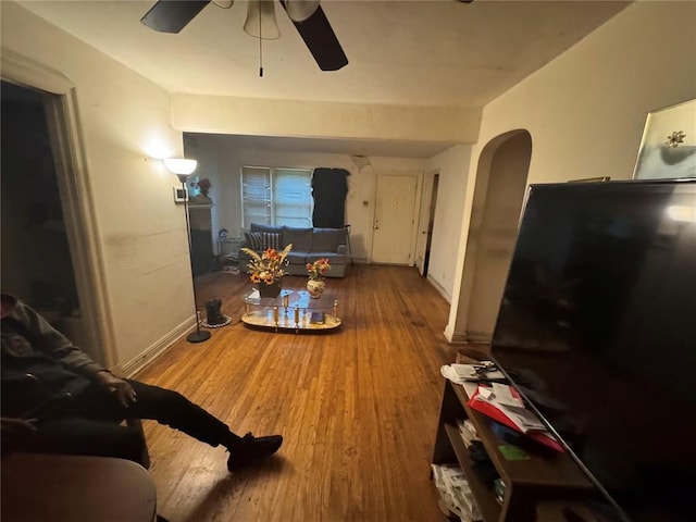 206 Thoroughman Ave, Ferguson, MO 63135 - living room featuring arched walkways, a ceiling fan, and wood finished floors