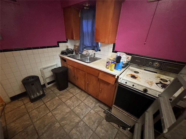 206 Thoroughman Ave, Ferguson, MO 63135 - kitchen with a sink, light countertops, white electric range oven, brown cabinetry, and wainscoting