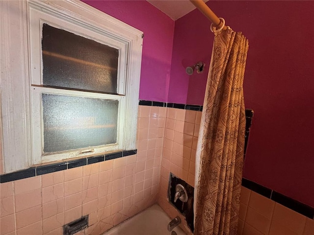 206 Thoroughman Ave, Ferguson, MO 63135 - full bathroom with a wainscoted wall, tile walls, and shower / bath combo
