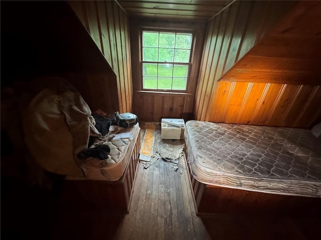 206 Thoroughman Ave, Ferguson, MO 63135 - bedroom with wooden walls and hardwood / wood-style floors