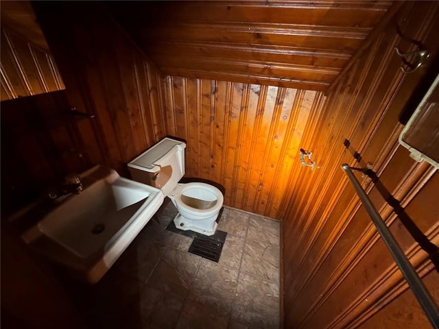 206 Thoroughman Ave, Ferguson, MO 63135 - half bathroom with wooden walls, toilet, and a sink