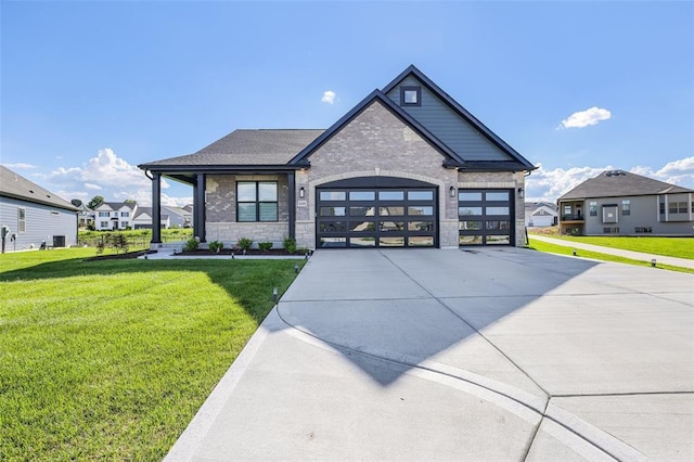 535 Crail Ct, Ofallon, MO 63368 - view of front facade with concrete driveway, a front lawn, stone siding, and a garage