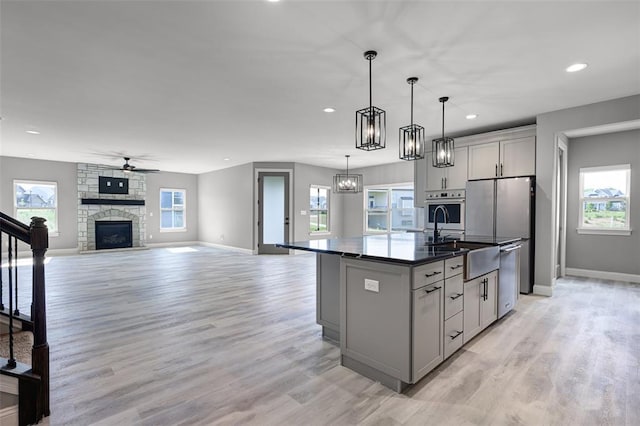 535 Crail Ct, Ofallon, MO 63368 - kitchen featuring gray cabinets, appliances with stainless steel finishes, a sink, plenty of natural light, and recessed lighting