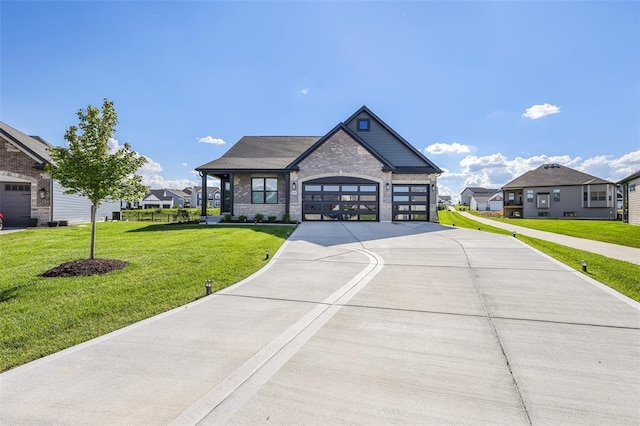 535 Crail Ct, Ofallon, MO 63368 - view of front facade with stone siding, concrete driveway, a front lawn, an attached garage, and a residential view