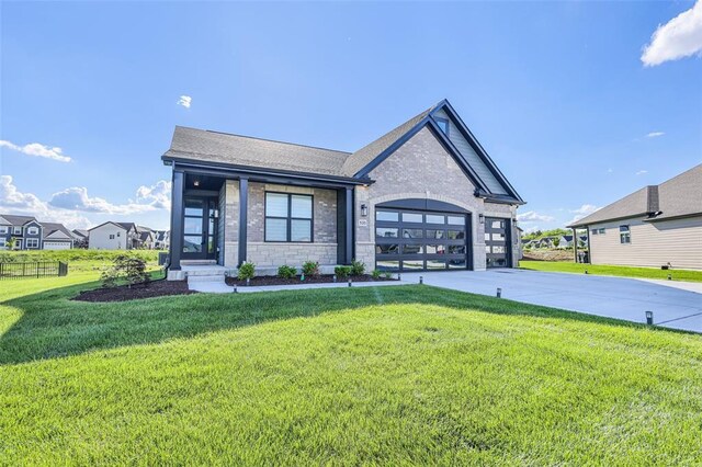 535 Crail Ct, Ofallon, MO 63368 - view of front facade with driveway, a front lawn, brick siding, a garage, and roof with shingles