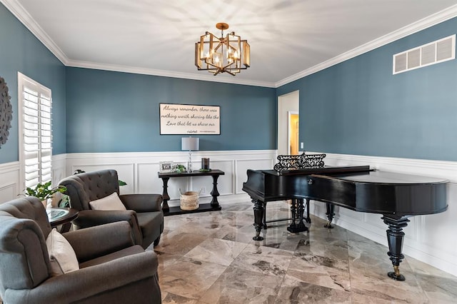 living area featuring a chandelier, ornamental molding, a decorative wall, wainscoting, and marble tiled flooring