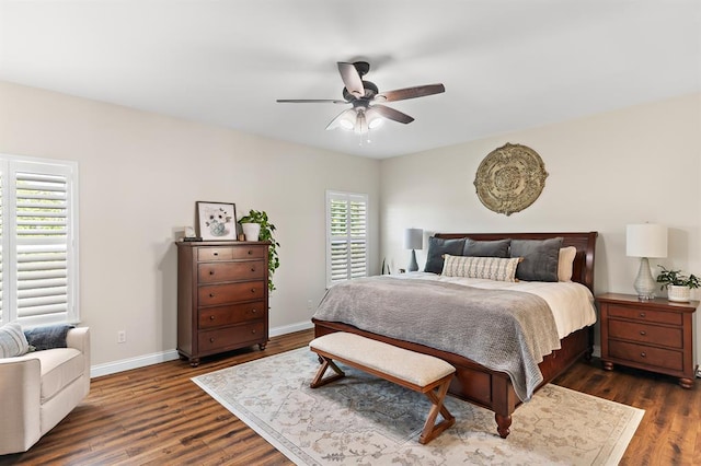 bedroom featuring dark wood-style flooring, baseboards, and a ceiling fan