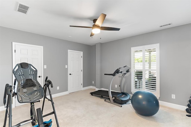 workout room featuring a ceiling fan, baseboards, and carpet