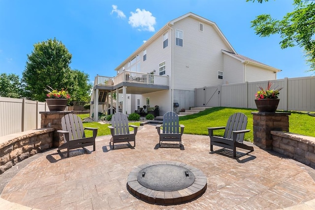 view of patio / terrace featuring stairs, a gate, a fire pit, and a wooden deck