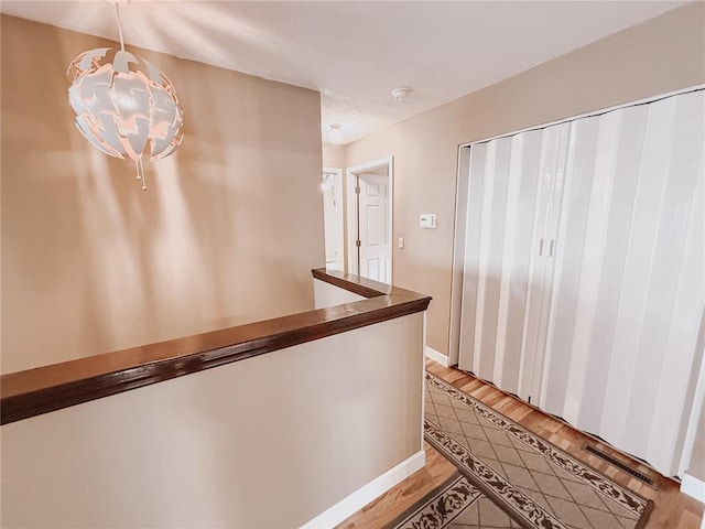 222 Elm Dr, Fairview Heights, IL 62208 - corridor with a chandelier, light wood finished floors, and baseboards