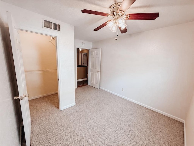 222 Elm Dr, Fairview Heights, IL 62208 - unfurnished bedroom with light colored carpet, baseboards, and a ceiling fan