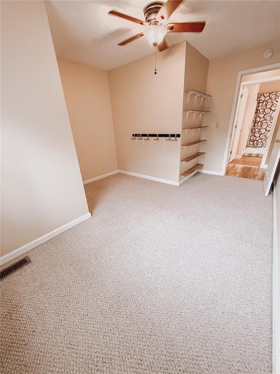 222 Elm Dr, Fairview Heights, IL 62208 - carpeted spare room featuring ceiling fan, baseboards, and a smoke detector