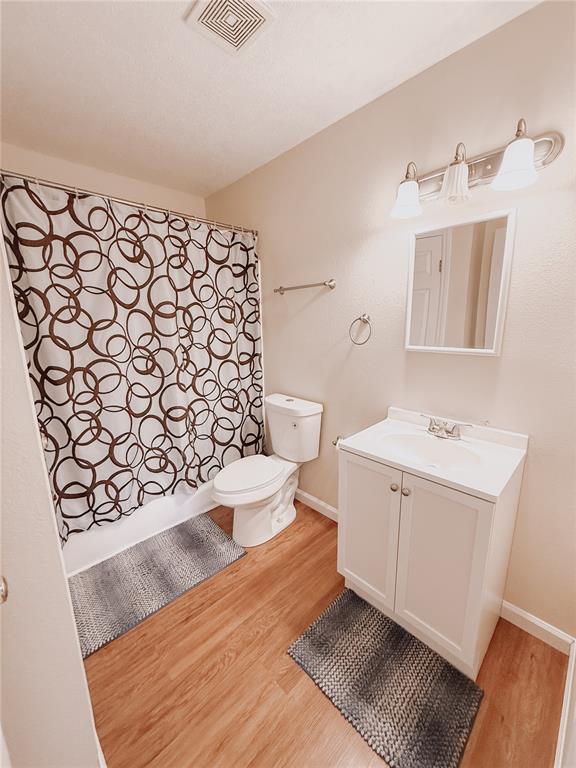 222 Elm Dr, Fairview Heights, IL 62208 - bathroom featuring wood finished floors, vanity, baseboards, and toilet