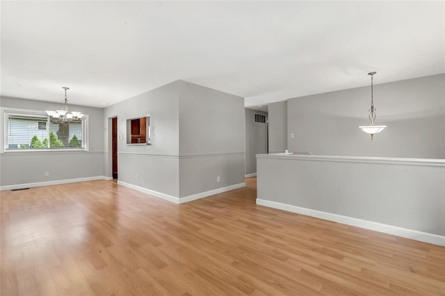 1137 Great Falls Ct, Manchester, MO 63021 - spare room with a chandelier, baseboards, and light wood finished floors