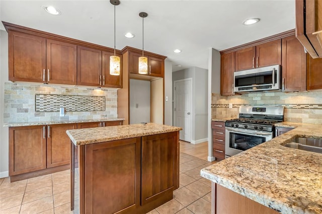 1137 Great Falls Ct, Manchester, MO 63021 - kitchen featuring stainless steel appliances, light tile patterned floors, baseboards, light stone countertops, and recessed lighting