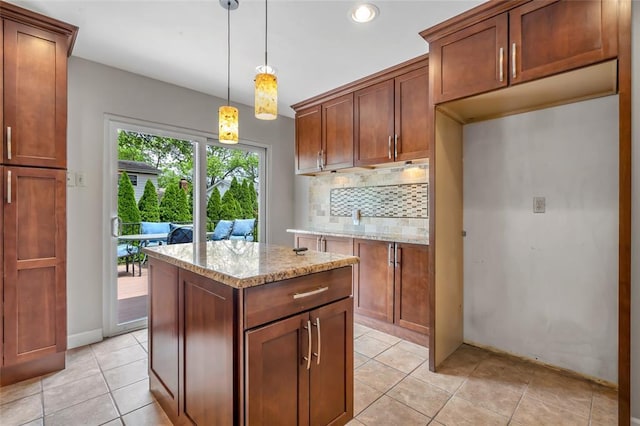 1137 Great Falls Ct, Manchester, MO 63021 - kitchen featuring light stone counters, decorative backsplash, light tile patterned floors, a kitchen island, and recessed lighting