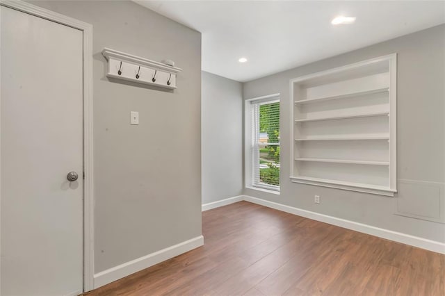 1137 Great Falls Ct, Manchester, MO 63021 - empty room featuring wood finished floors, baseboards, recessed lighting, and built in shelves